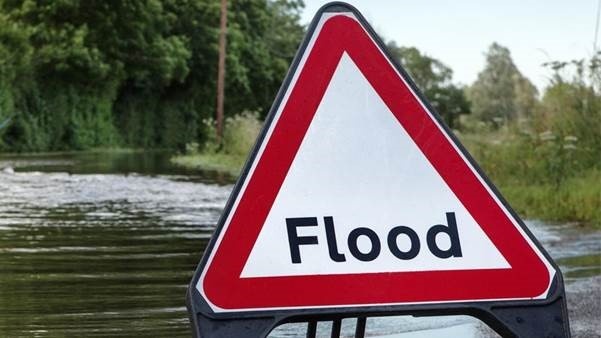 Flooding Sign in front pf a flooded street