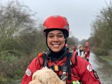 Rescue person holding a dog