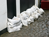 Sandbags are stacked up against doors to protect property from flood water