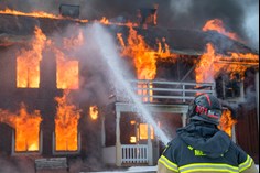 Firefighters tackling a blaze with hoses