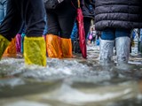 Colourful wellies walking through flooded streets