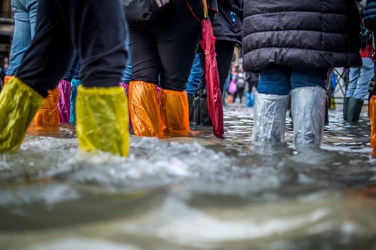 Colourful wellies walking through flooded streets